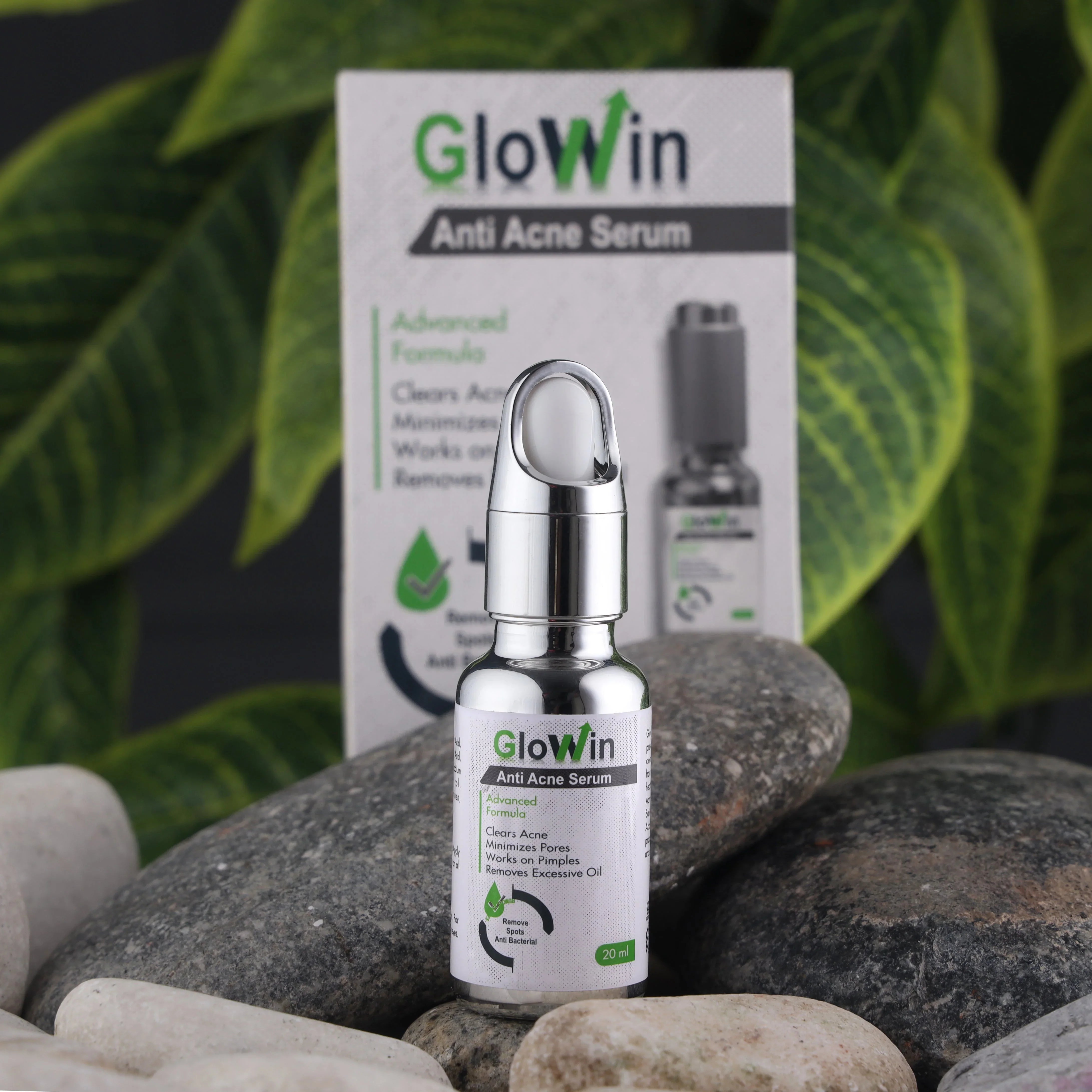 Glowin anti acne serum bottle with packaging, skincare product for acne treatment, outdoors with leaves and stones