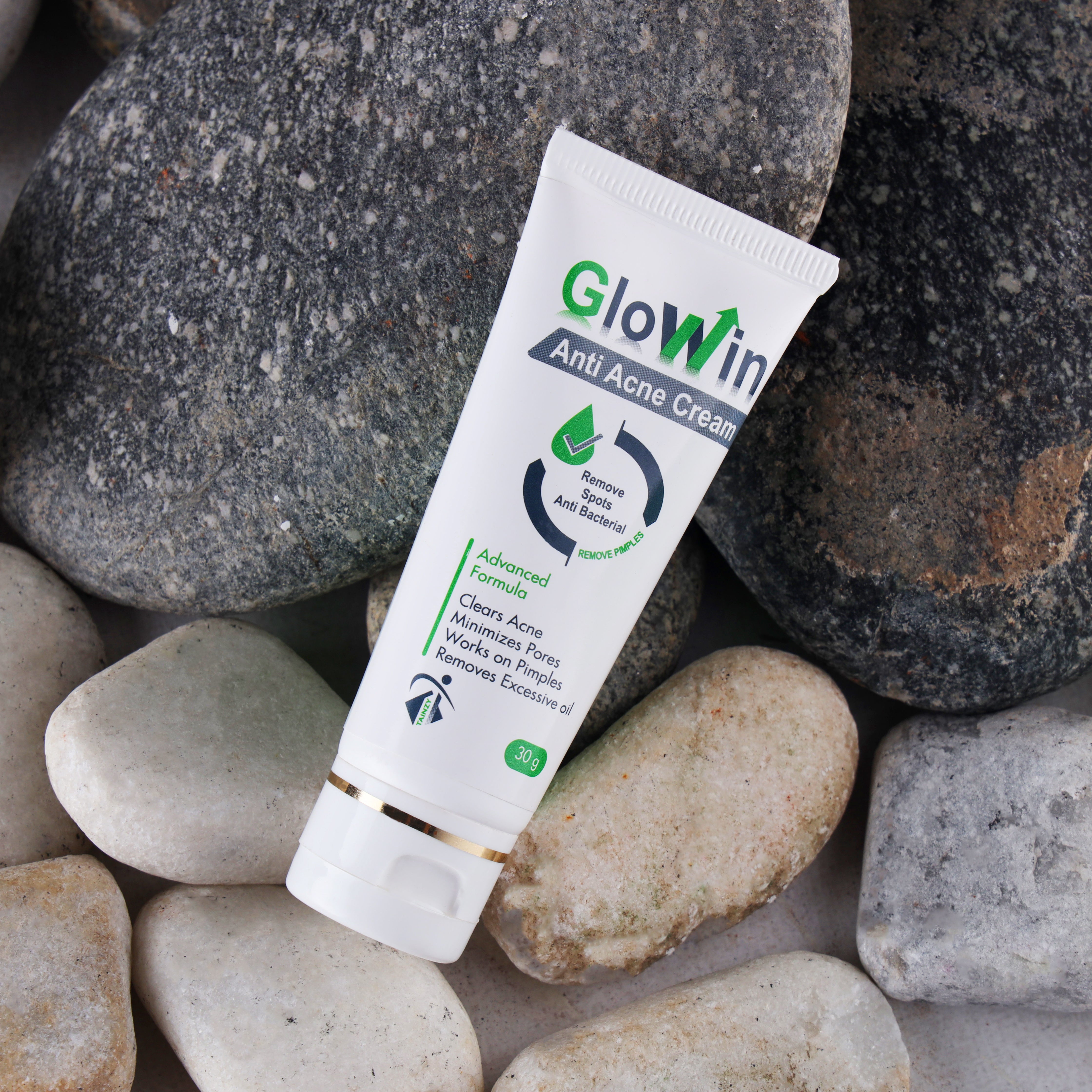 Glowin anti-acne cream tube on smooth stones, advanced acne treatment skincare product