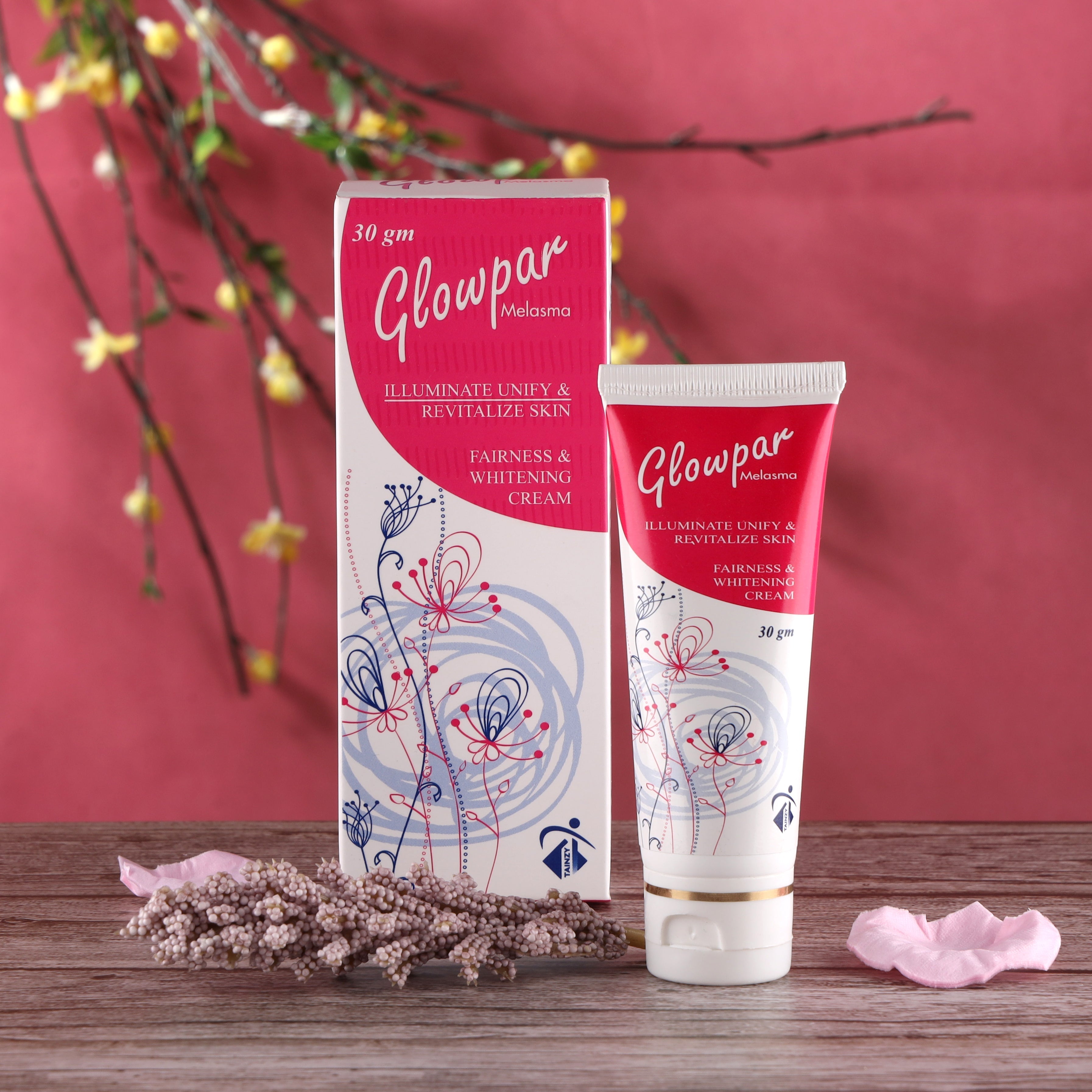 Glowpar Melasma fairness and whitening cream tube and box on wooden table with floral decor