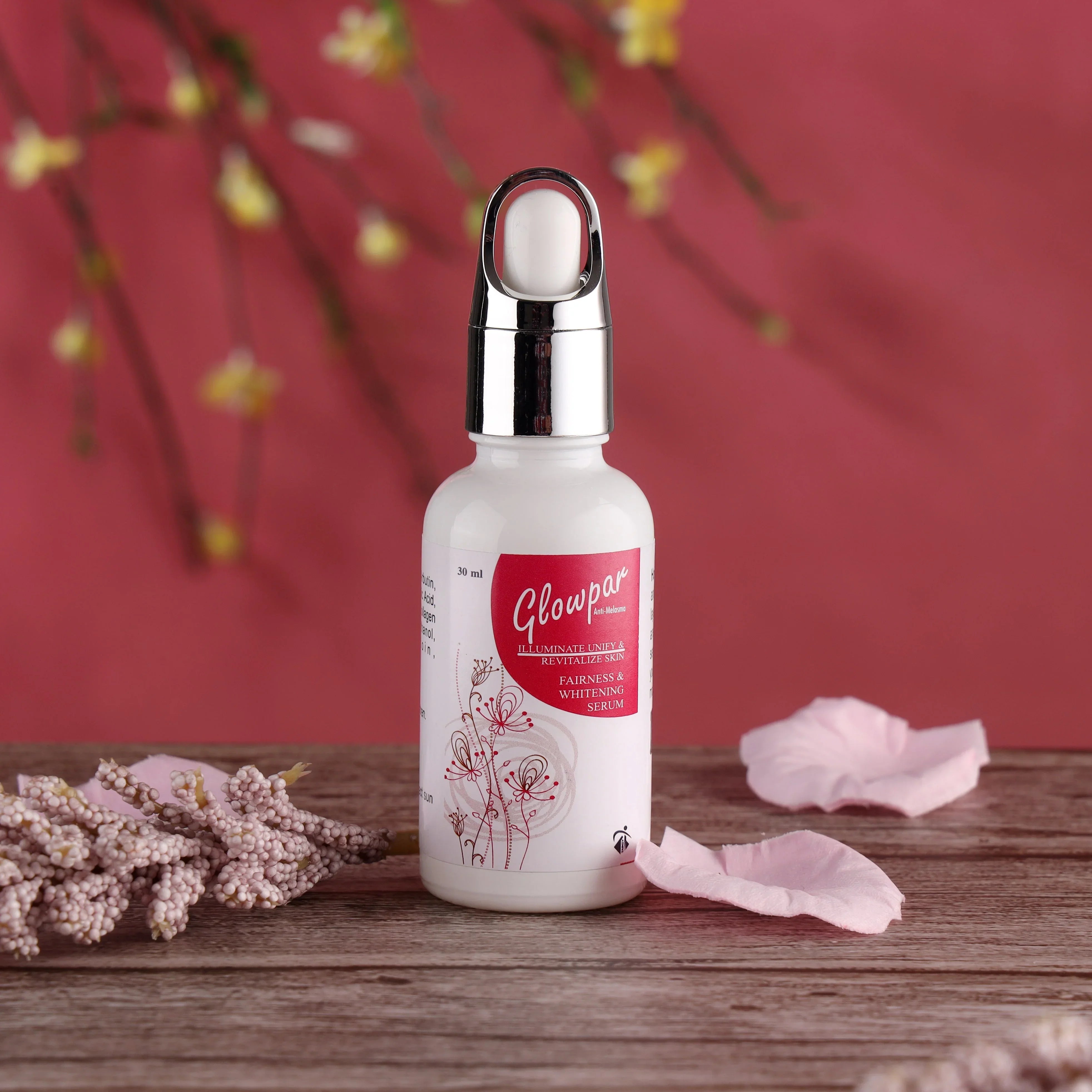 Glowpar fairness and whitening serum bottle on wooden table with pink floral background