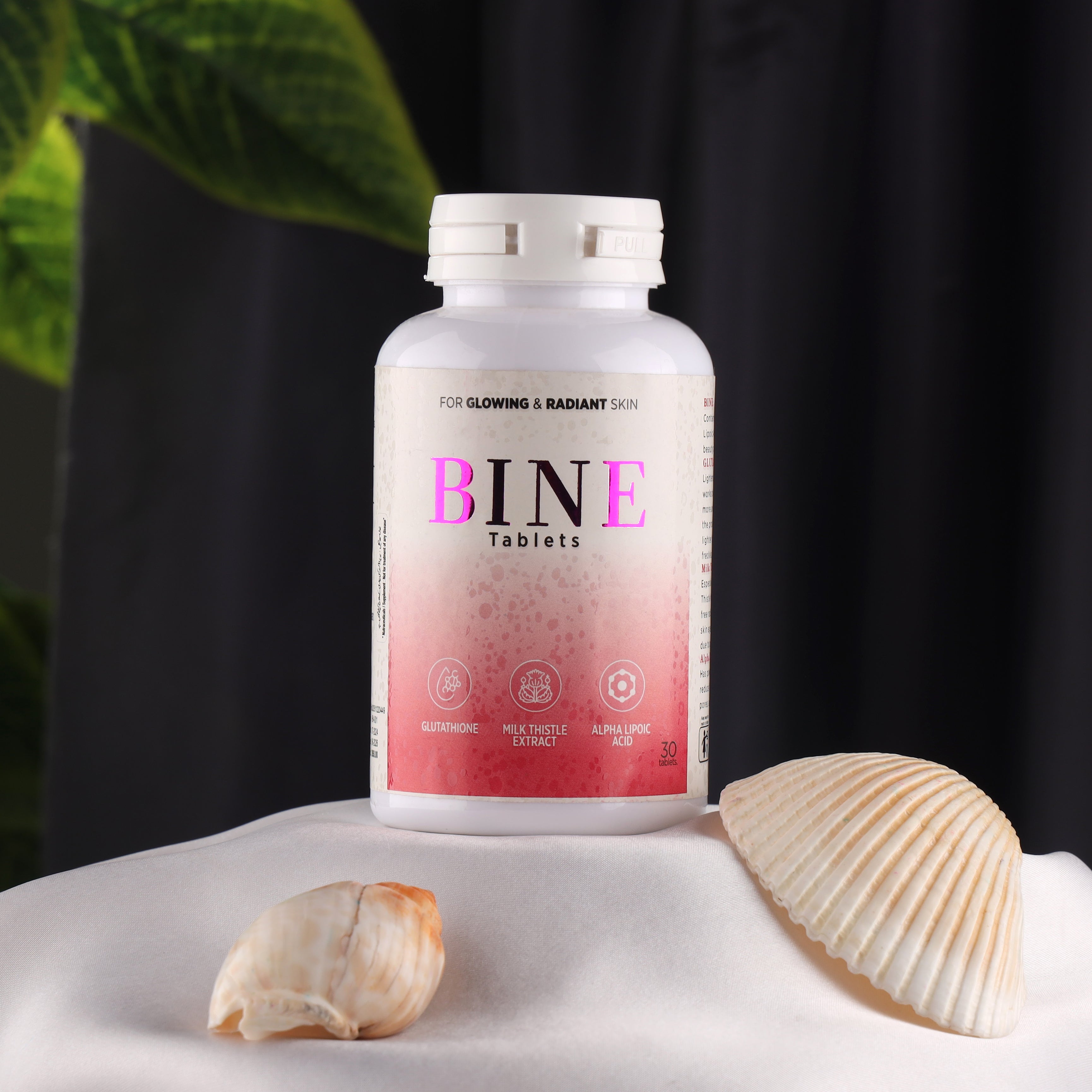 BINE tablets bottle for glowing radiant skin with seashells, skincare supplement product photo