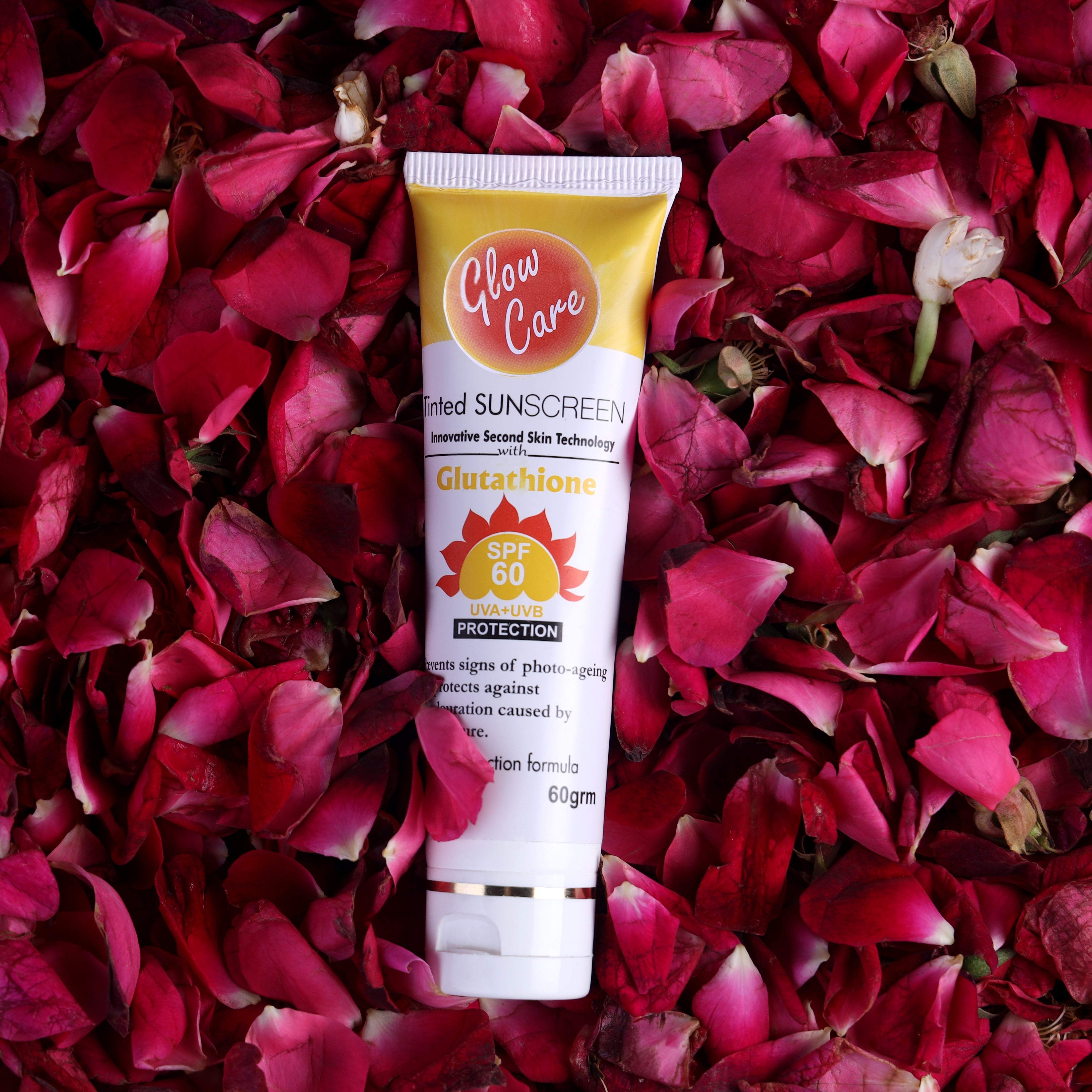 SPF 60 sunscreen tube with glutathione on rose petals, skin care product photo