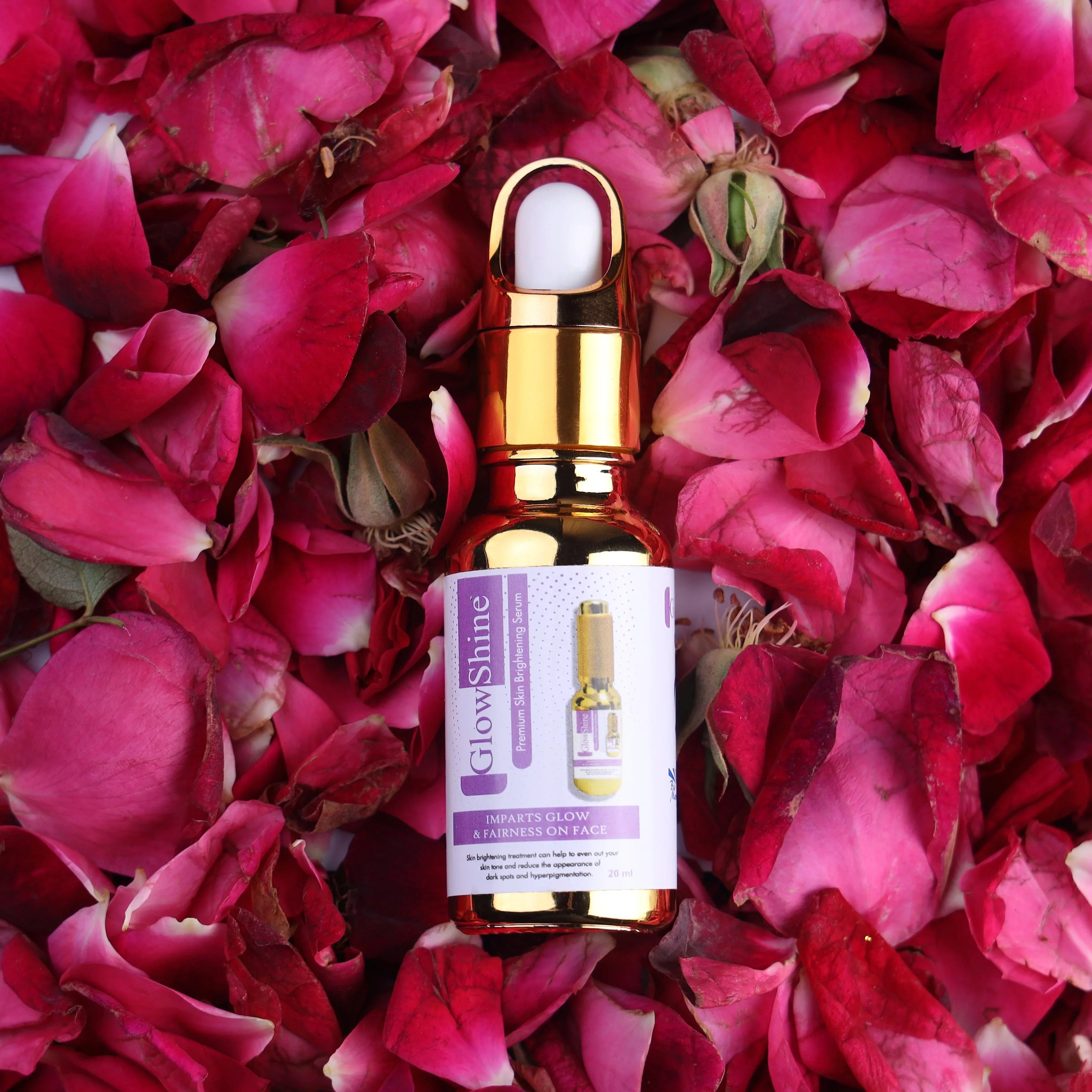 GlowShine skin brightening serum bottle on pink rose petals, skincare product photography