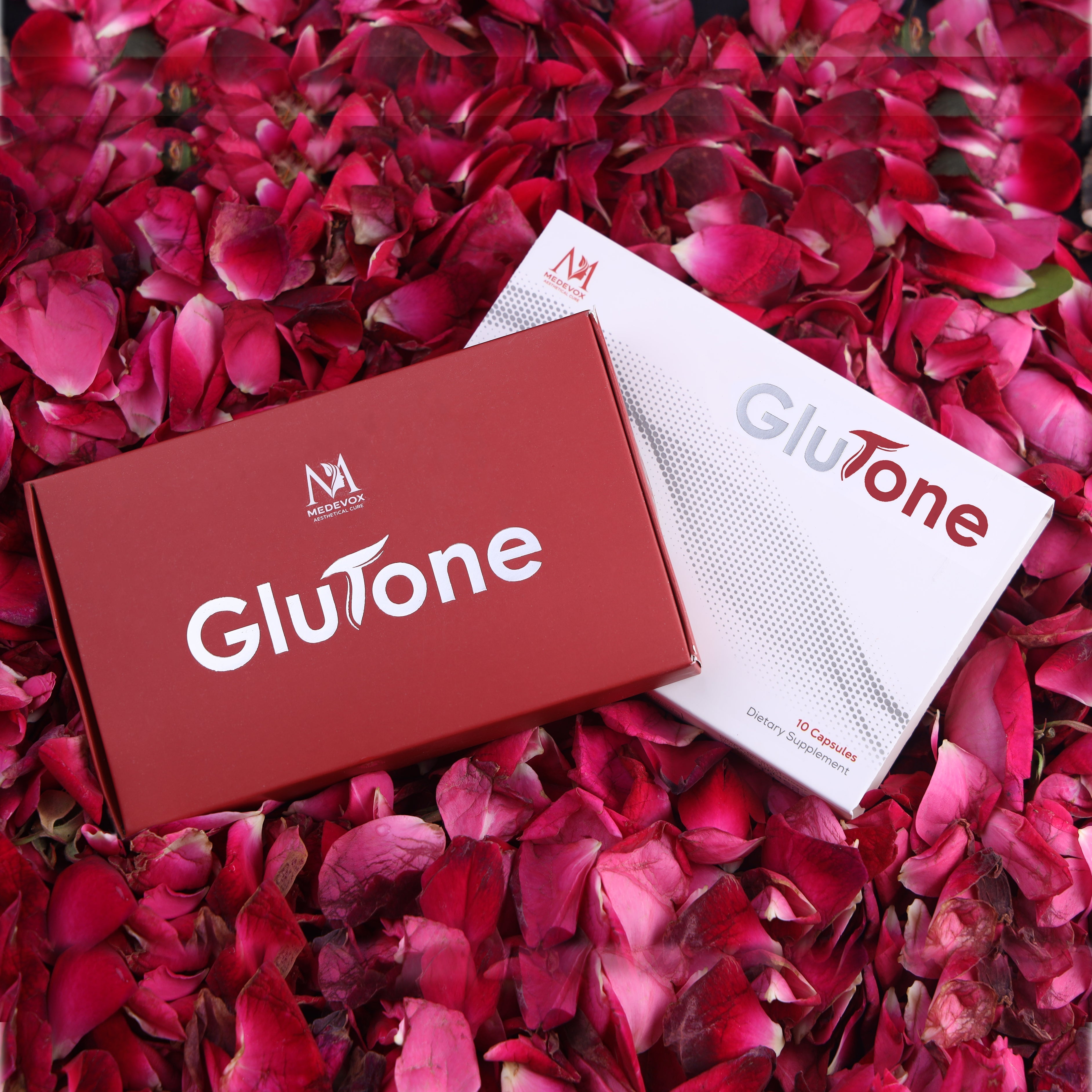 Glutone dietary supplement boxes on pink rose petals, skincare and beauty product