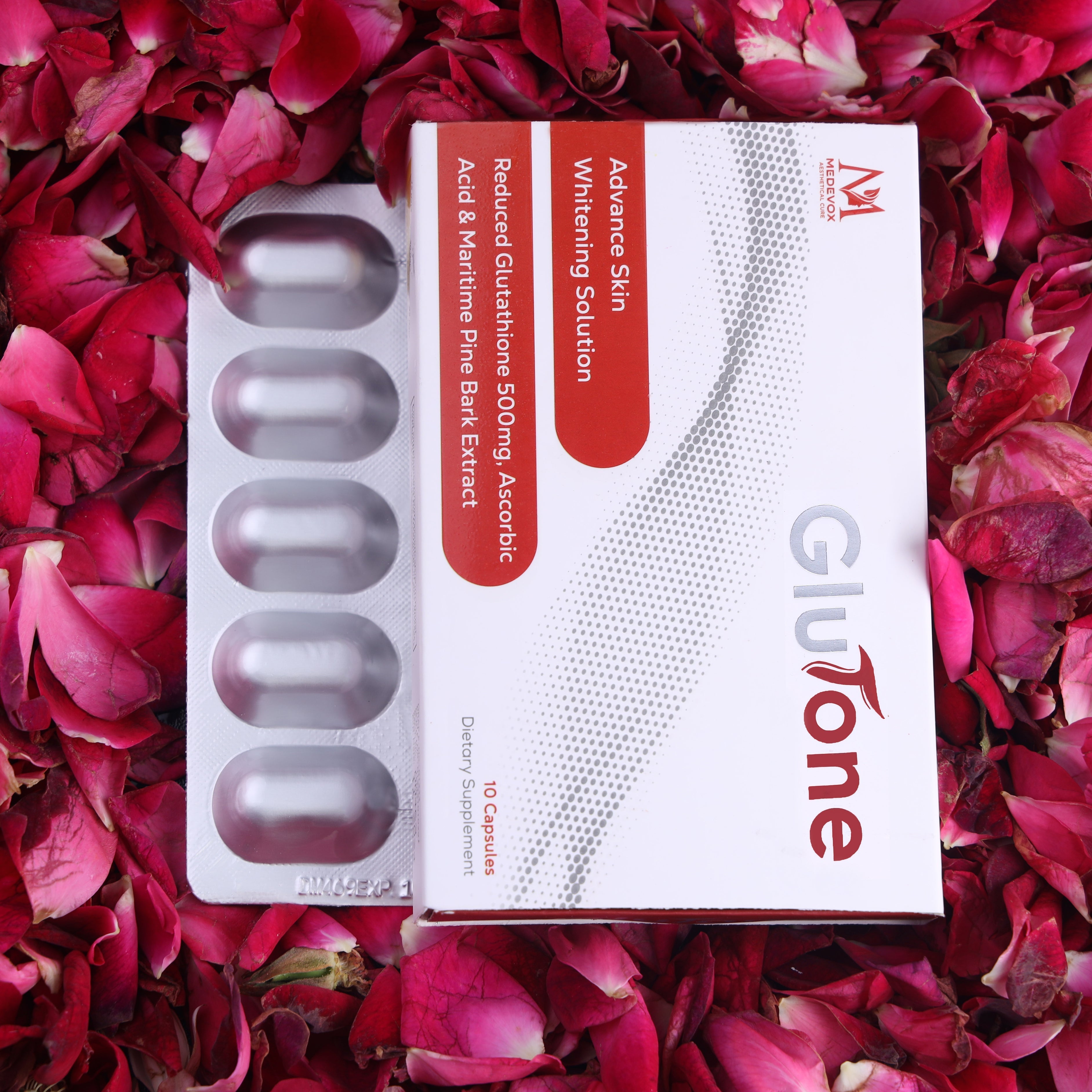 Glutone skin whitening capsules box with blister pack on pink rose petals