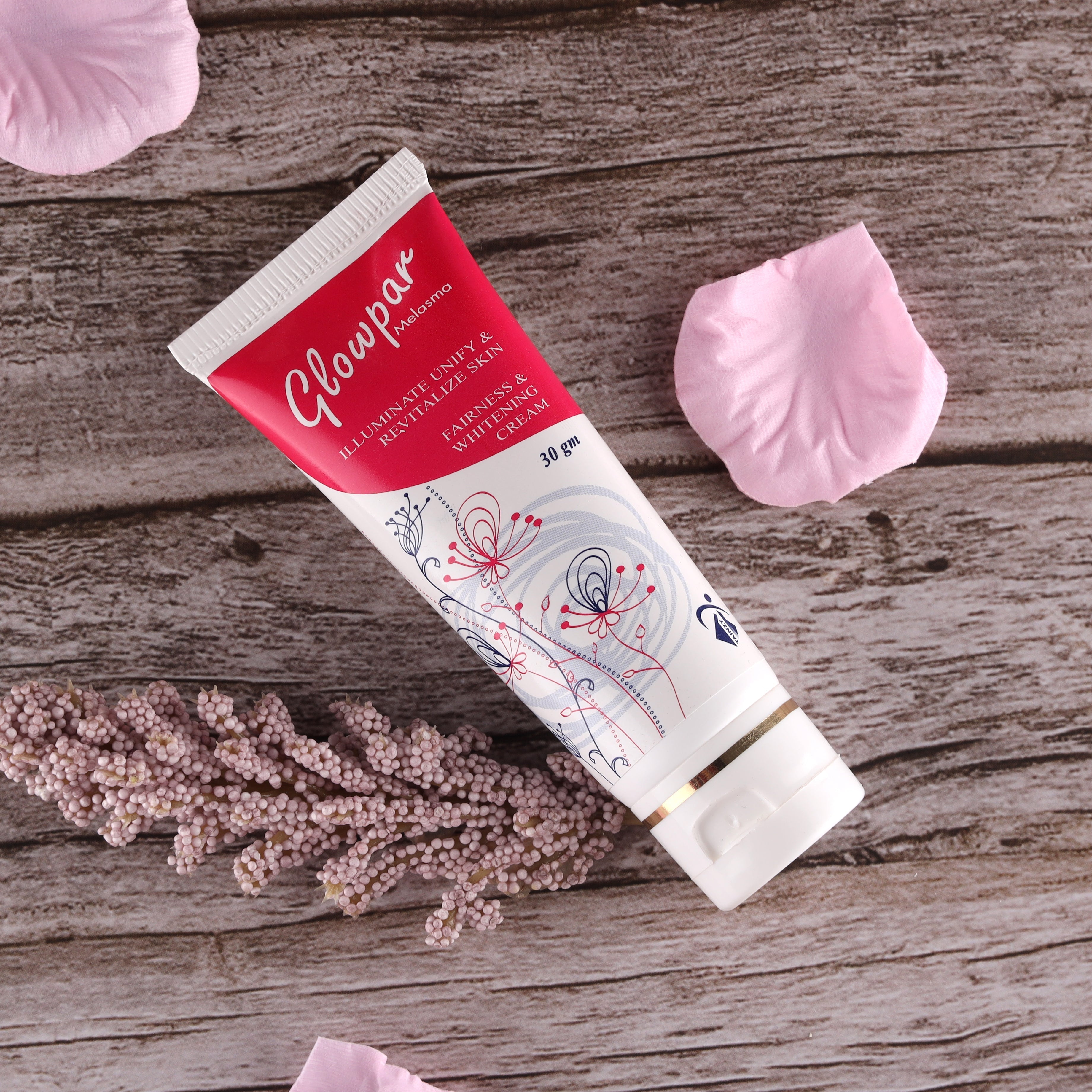 Glowpar fairness and whitening cream tube on rustic wood with pink petals, skincare product