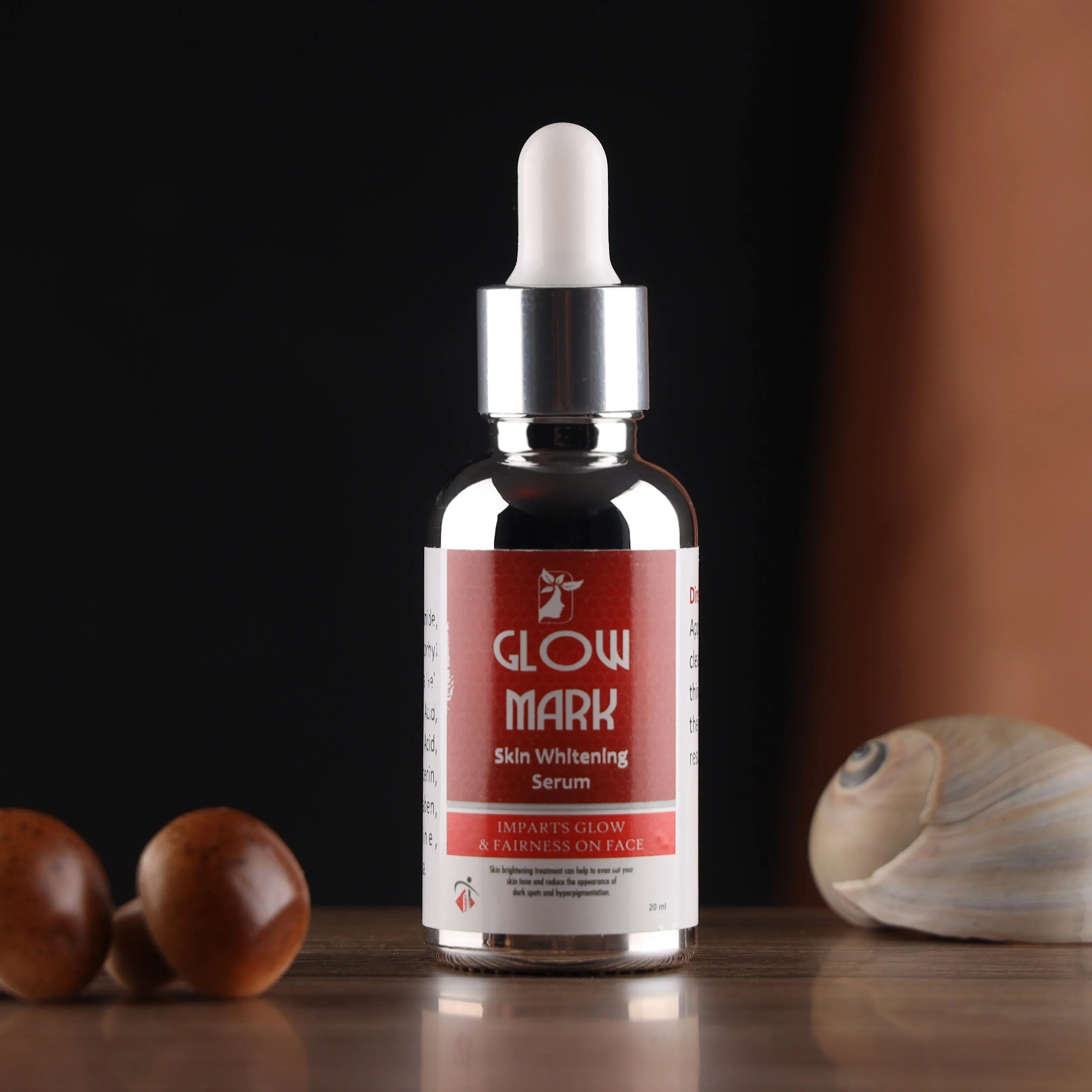 Glow Mark skin whitening serum bottle with dropper on wooden surface, natural skincare product