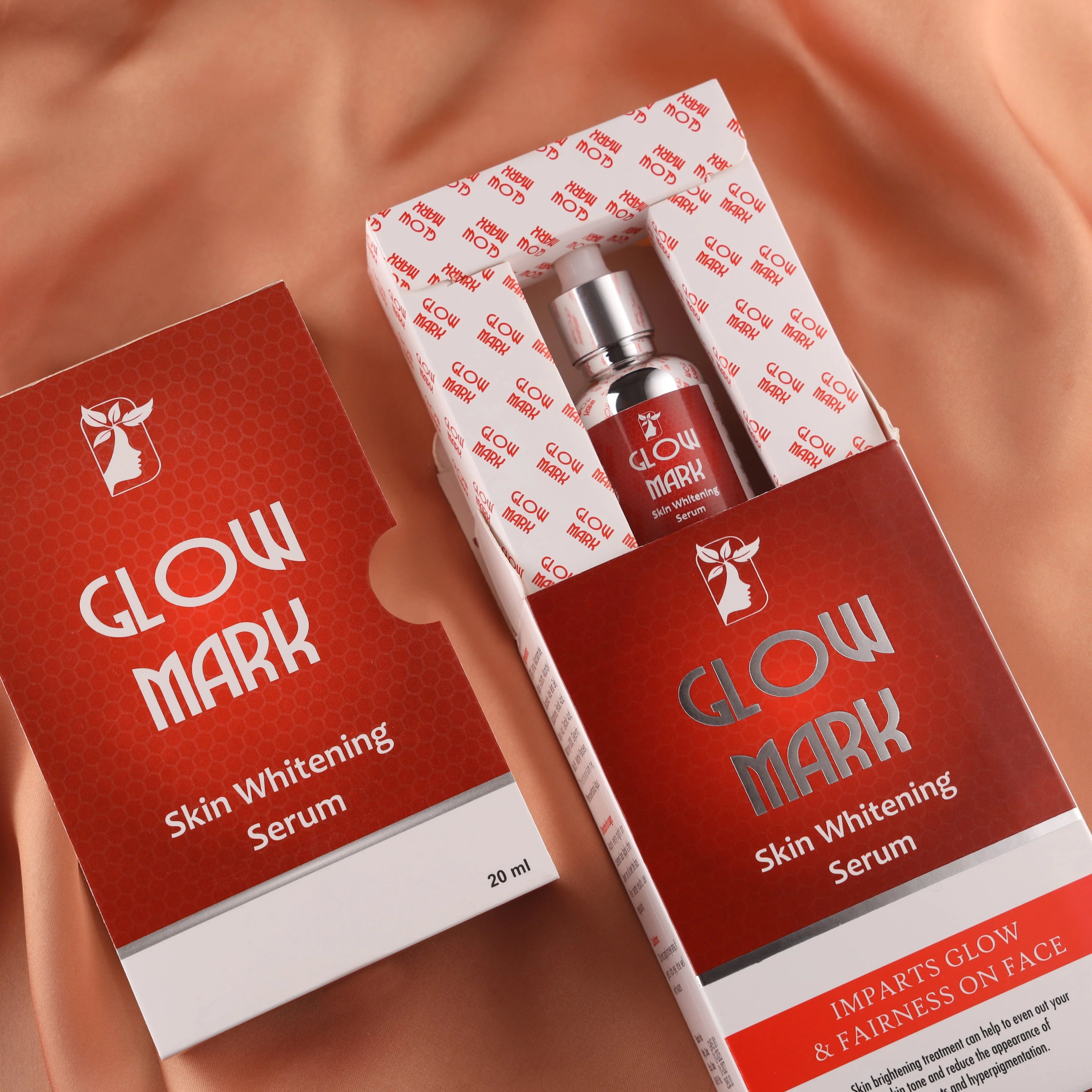 Glow Mark Skin Whitening Serum 20ml packaging and bottle on peach silk fabric