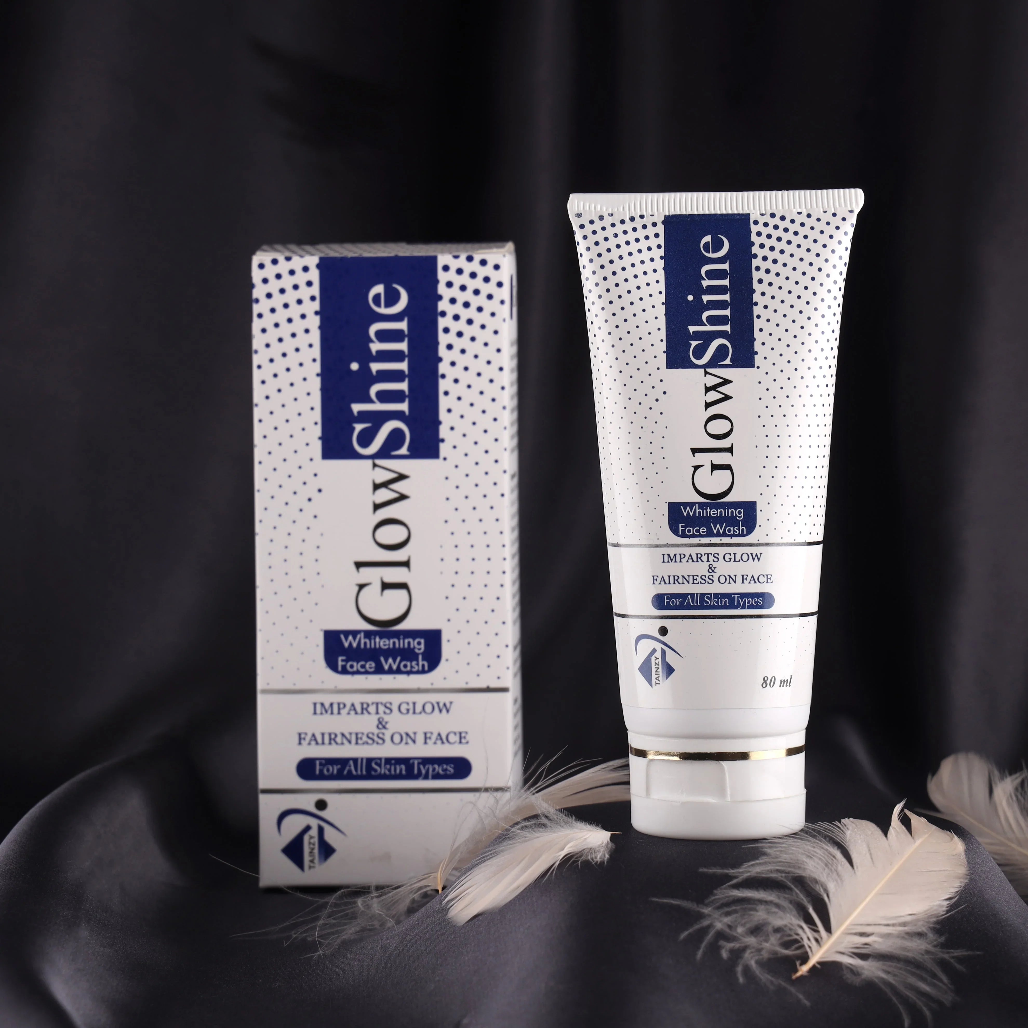 GlowShine whitening face wash tube and box on black fabric, skincare product for all skin types