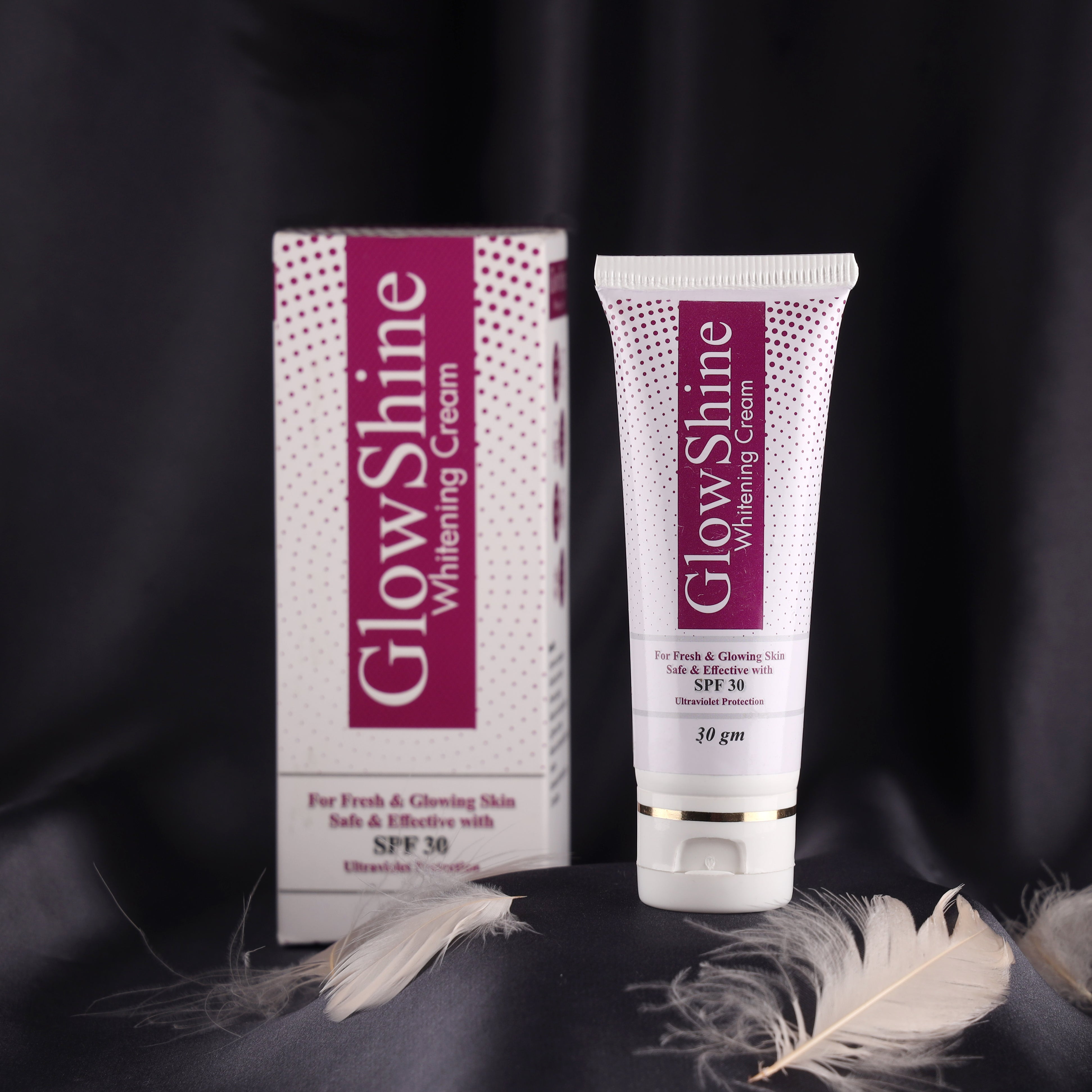 GlowShine whitening cream with SPF 30 for glowing skin, tube and box on black background